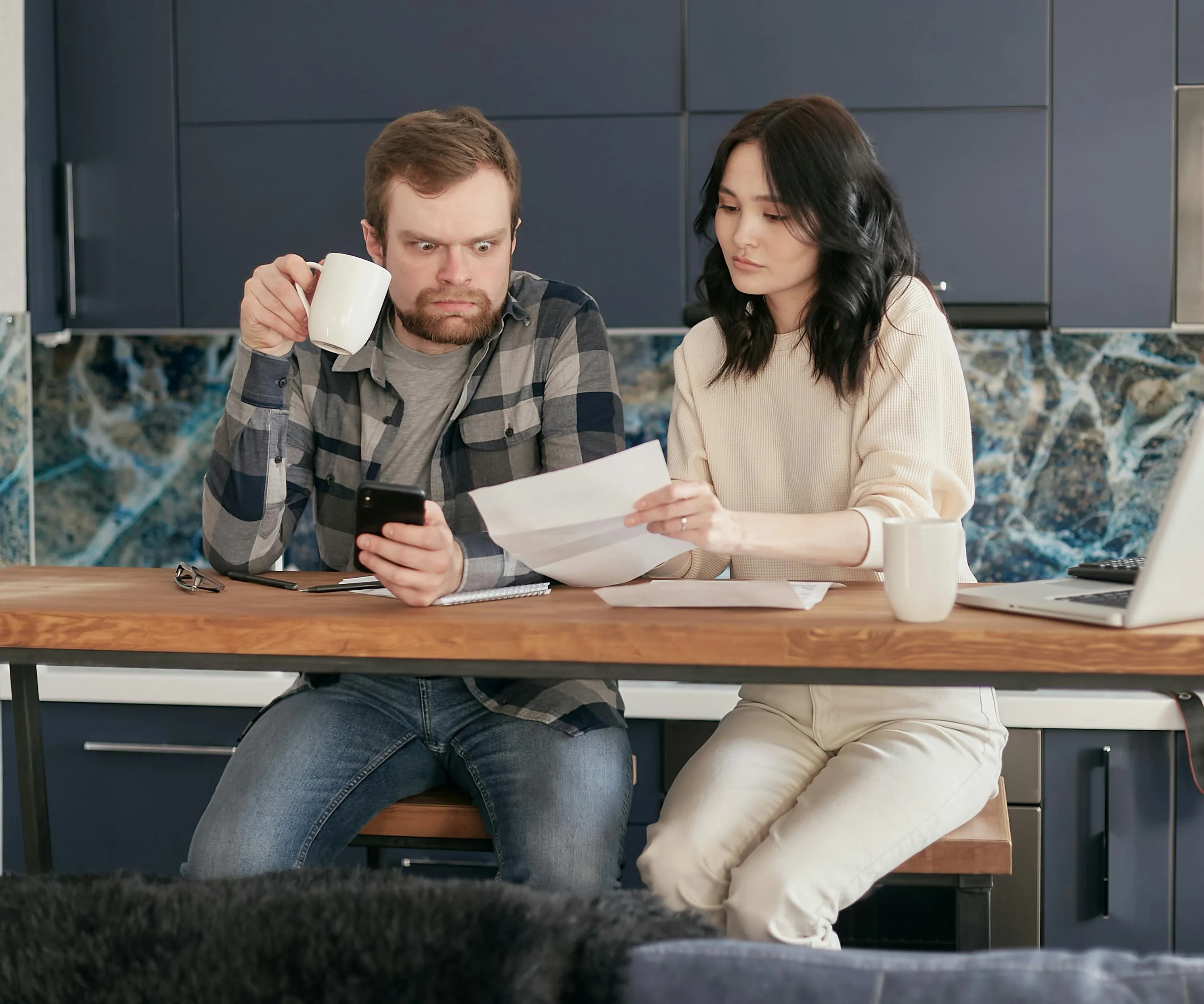 A couple reviewing their lease together at the kitchen table